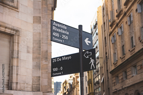 Carteles indicativos de la intersección de la Avenida Rivadavia con Calle  25 de Mayo en la Ciudad de Buenos Aires, Argentina photo