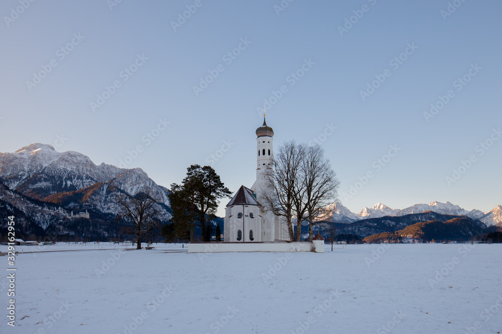 St. Coloman church at sunrise in winter. Allgäu, Germany