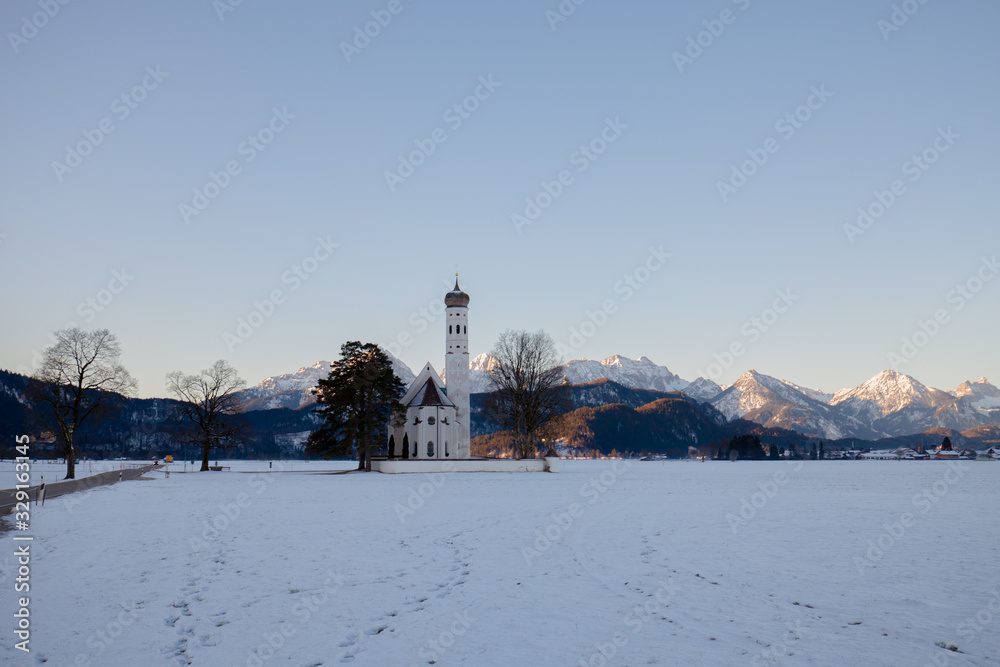 St. Coloman church at sunrise in winter. Allgäu, Germany St. Coloman church at sunrise in winter. Allgäu, Germany
