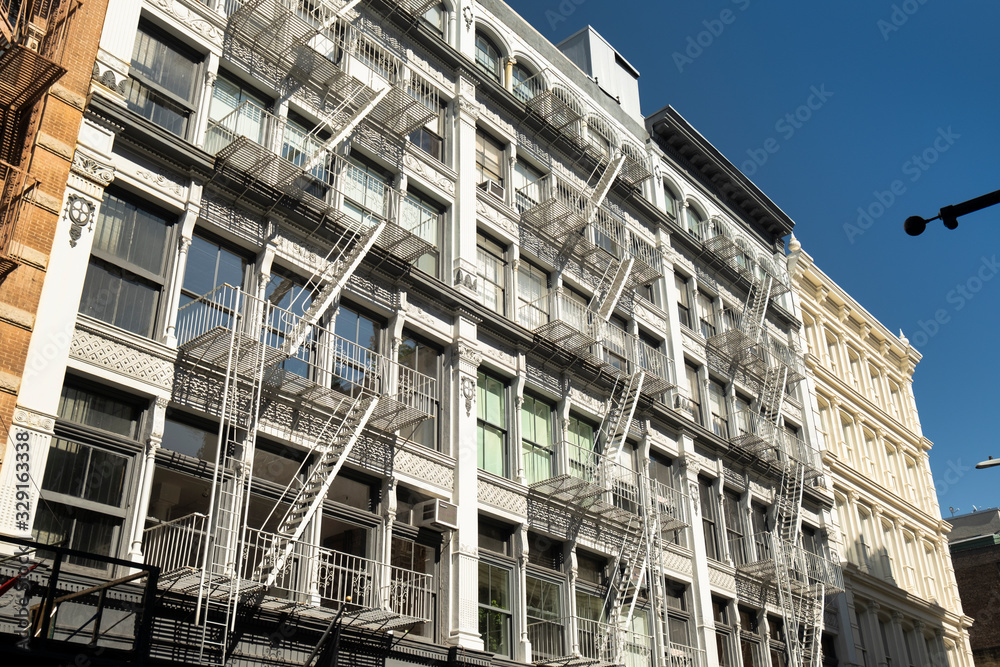 Downtown Manhattan SoHo apartment building details with outdoor fire escapes in downtown Manhattan New York City USA Downtown Manhattan SoHo apartment building details with outdoor fire escapes in downtown Manhattan New York City USA