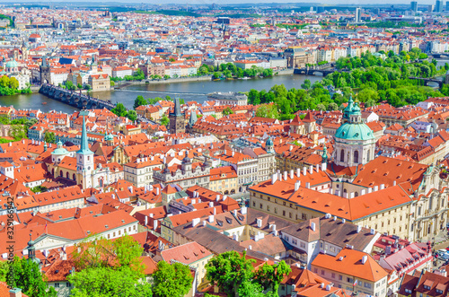 Top aerial view of Prague historical city centre with red tiled roof buildings in Mala Strana Lesser Town and Old Town, Charles Bridge Karluv Most over Vltava river, Bohemia, Czech Republic