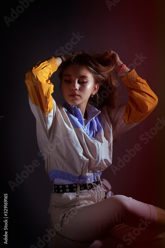 Teen girl in stylish clothes. Trend photos in 90s style. Toning photos with highlights.