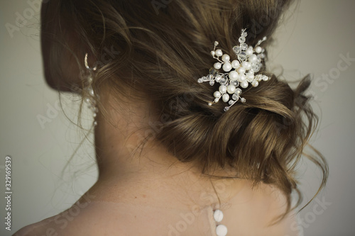 Bridal wedding hairstyle with jewelry. Elegant hair accessorie.