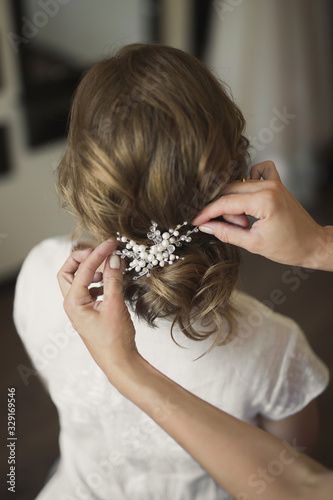 Bridal wedding hairstyle with jewelry. Elegant hair accessorie.