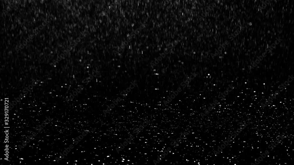 Heavy droplets of rain falling on the surface against an isolated background