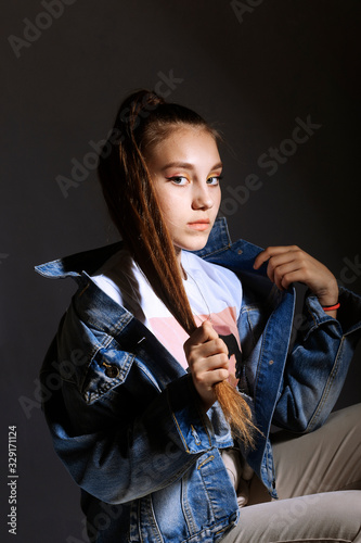 Teen girl in stylish clothes. Trend photos in 90s style. Toning photos with highlights.