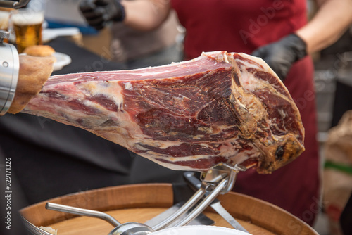 Spanish appetizer ham Authentic piece of Iberian ham cut by artisan hands with a special knife in very thin slices so that they preserve all the natural flavor of the product