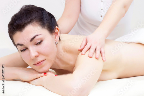 massage in a spa salon for a girl. Wellness massage concept. light background