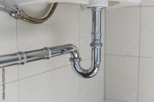 Obraz na płótnie metal sink siphon and drain in white bathroom w salonie
