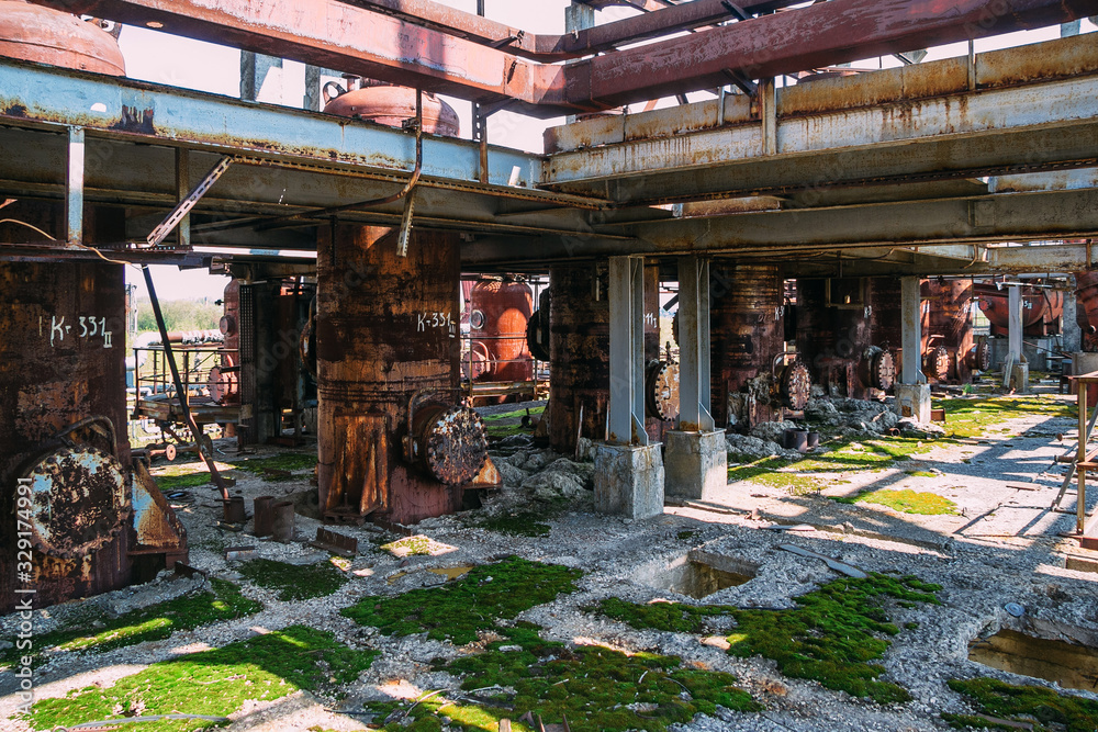 Abandoned ruined chemical plant with remain rusty tanks and pipes