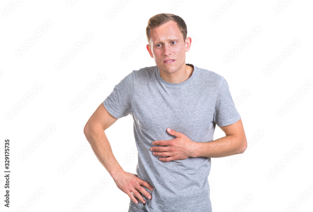 Young man holds on to his stomach, isolated on a white background. Intestinal pain. Young man holds on to his stomach, isolated on a white background. Intestinal pain.