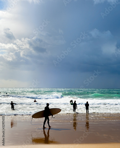 Surfers surfboards beach gr...