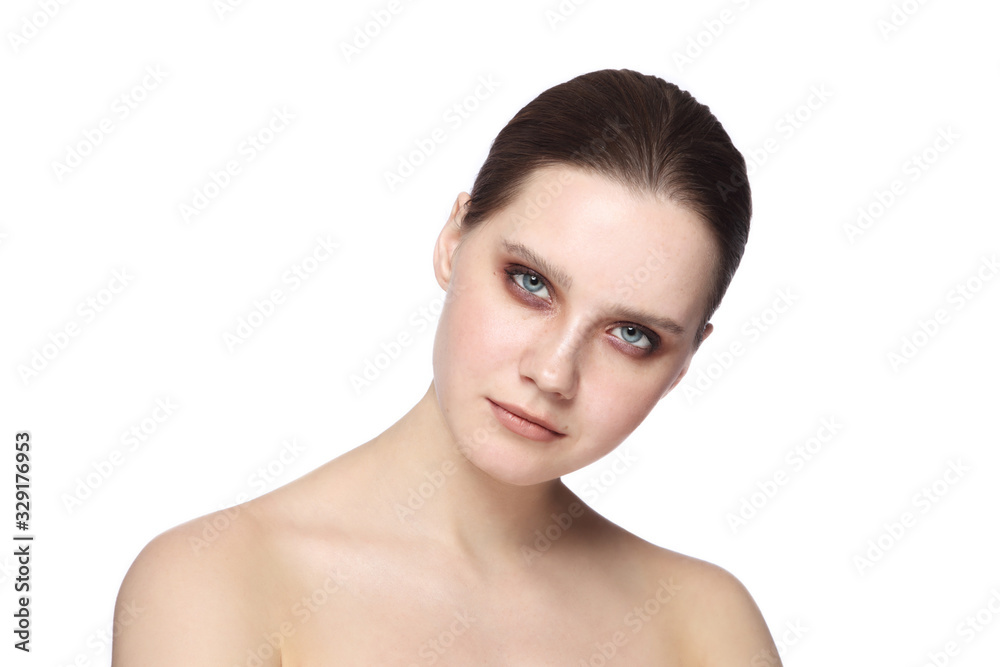 Portrait of young beautiful woman with smoky eye makeup over white background Portrait of young beautiful woman with smoky eye makeup over white background