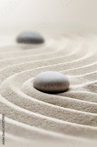 zen garden meditation stone background with stones and lines in sand for relaxation. photo