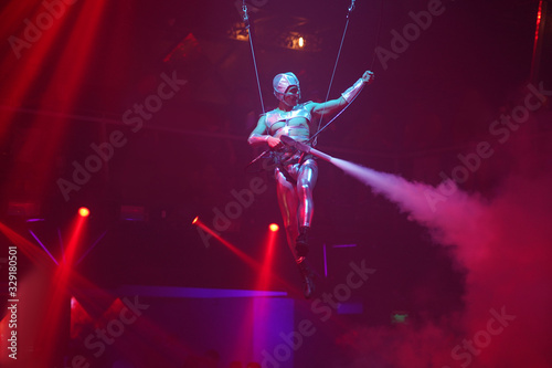 Air performance in night club. Sport training gym and lifestyle concept. Black background Circus show
