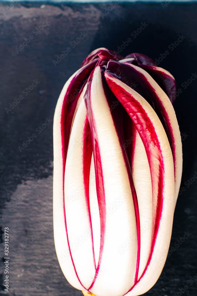 Radicchio Rosso di Treviso is on top of a black stone cutting board
