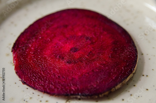 A thin red slice of a beetroot