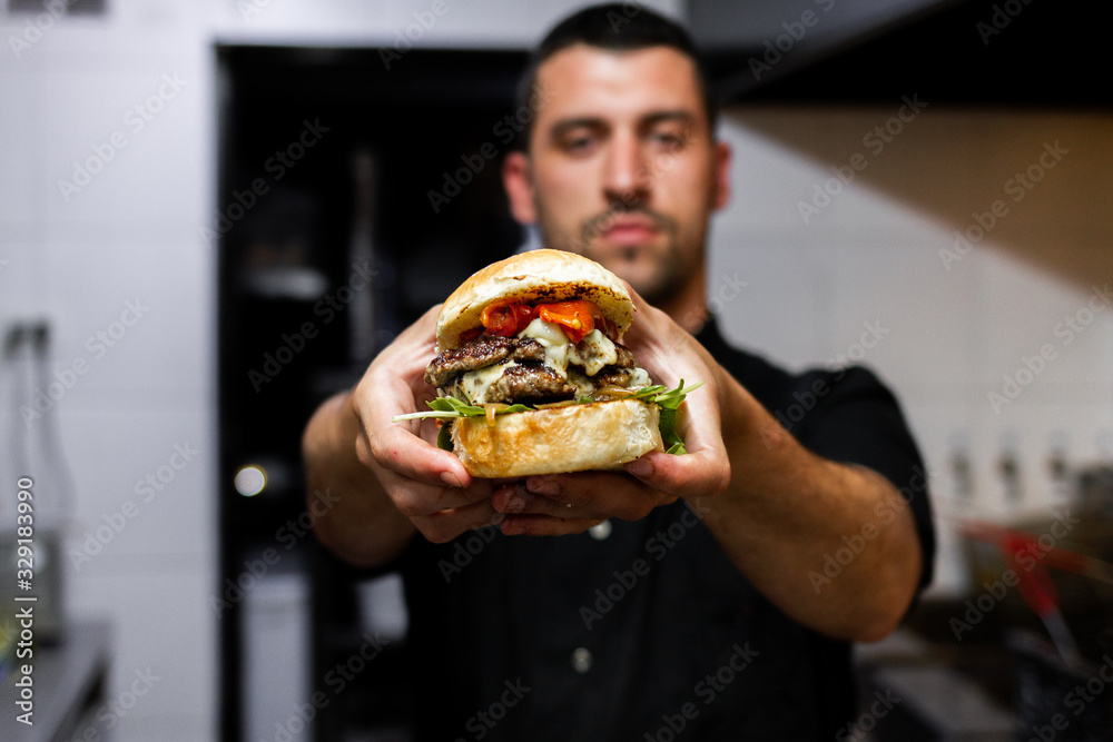 professional latin chef holding a prepared hamburger professional latin chef holding a prepared hamburger