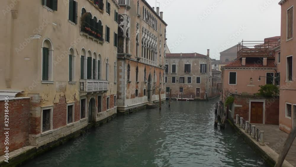Cloudy morning in Venice. A deserted canal and deserted embankment next to it. Cloudy morning in Venice. A deserted canal and deserted embankment next to it.