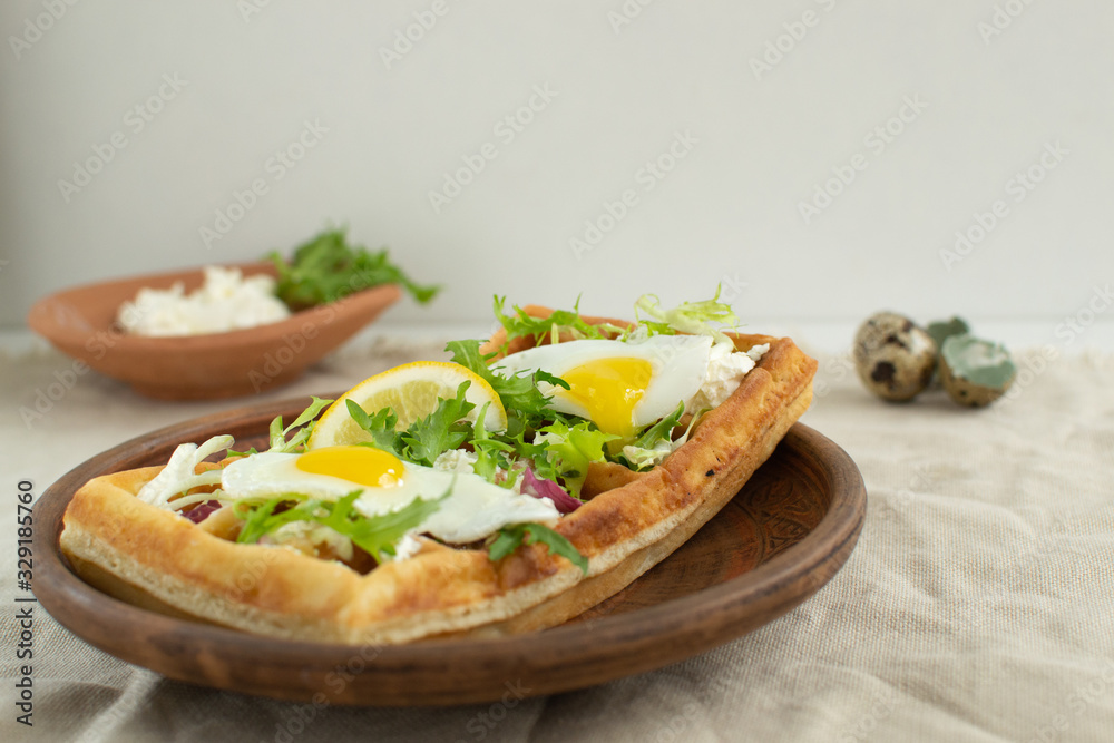 Belgian waffles with boiled quail eggs, mix of green leaves and cheese. Belgian waffles with boiled quail eggs, mix of green leaves and cheese.
