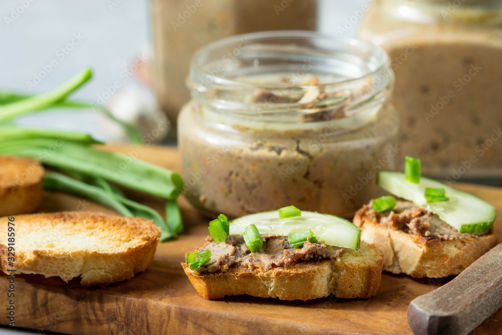 Sandwiches with homemade chicken liver pate on a cutting board. Sandwiches with homemade chicken liver pate on a cutting board.