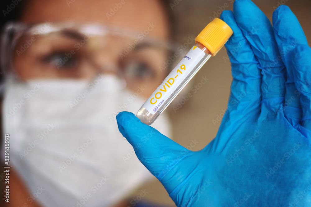 Biology and science. A scientist with test tube. Virus or bacteria cells. Global alert. Epidemic. COVID-19. Coronavirus. 2019-NCOV. Biology and science. A scientist with test tube. Virus or bacteria cells. Global alert. Epidemic. COVID-19. Coronavirus. 2019-NCOV.