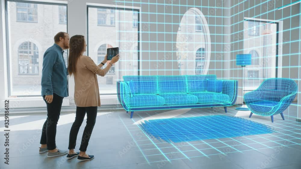 Decorating Apartment: Lovely Young Couple Use Digital Tablet with Augmented Reality Interior Design Software to Choose 3D Furniture for their Home. People Pick Sofa, Table and Lamp for Living Room