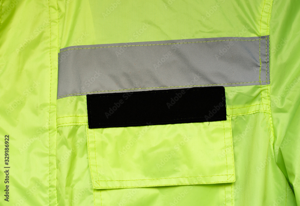 Background crumpled material of green color with a gray horizontal stripe and a label with a place for your text.