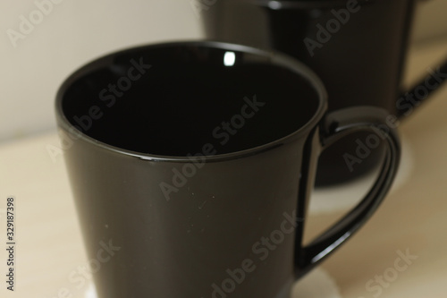 black porcelain cup on a bright wooden table