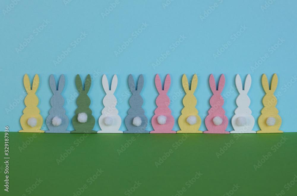 Easter bunnies on a green and light blue paper background