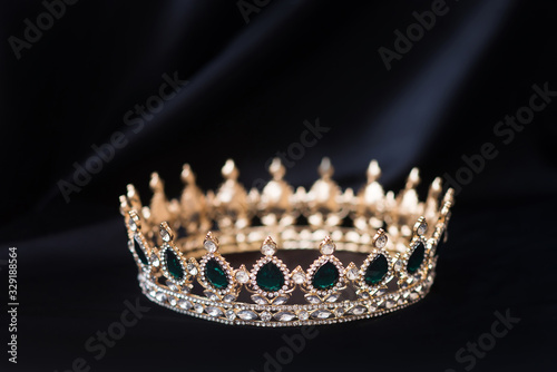 Vintage royal crown, jewellery with emeralds. Concept of power and wealth photo