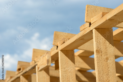 Wood board assembled on construction site. New frame structure of building. Scaffolding framework made from natural materials. Wooden floor or ceiling. Elements and components of the construction.