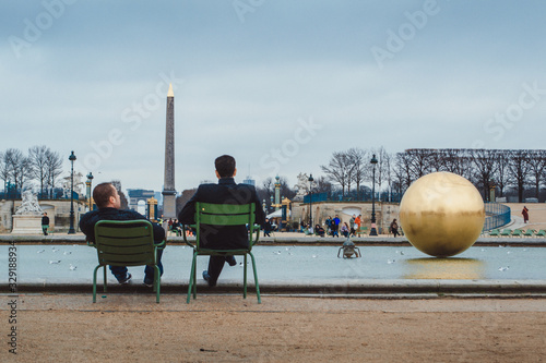 Two men talking in Tuilleries Garden, Paris, France photo