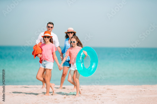 Happy beautiful family on a tropical beach vacation