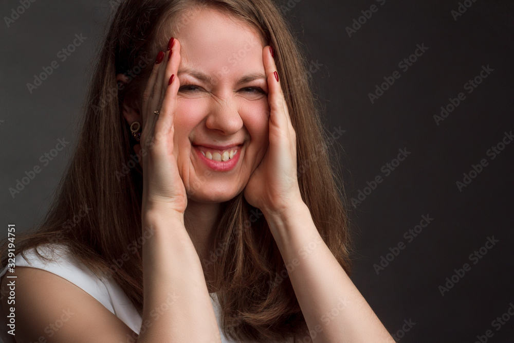A photo of a woman with brown straight hair posing in white shirt on dark background in Studio A photo of a woman with brown straight hair posing in white shirt on dark background in Studio