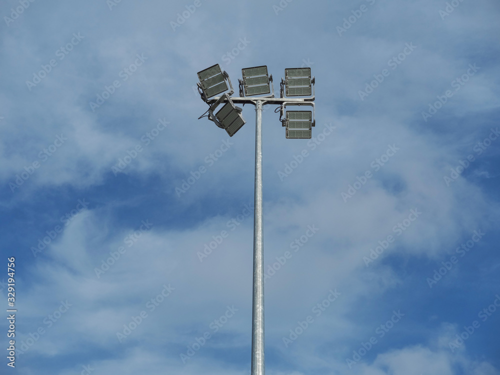 Modern LED lights on a poles against a cloudy blue background. Modern LED lights on a poles against a cloudy blue background.