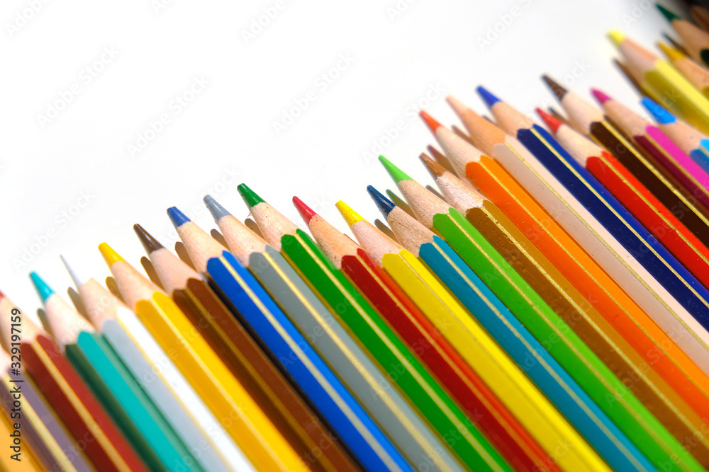 Crayons - colored pencil set arranged on white background