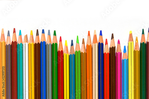 Crayons - colored pencil set arranged on white background