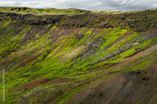 Wonderful icelandic nature landscape. View from the top. High mountains  mountain river and green grassland. Green meadows. Iceland.