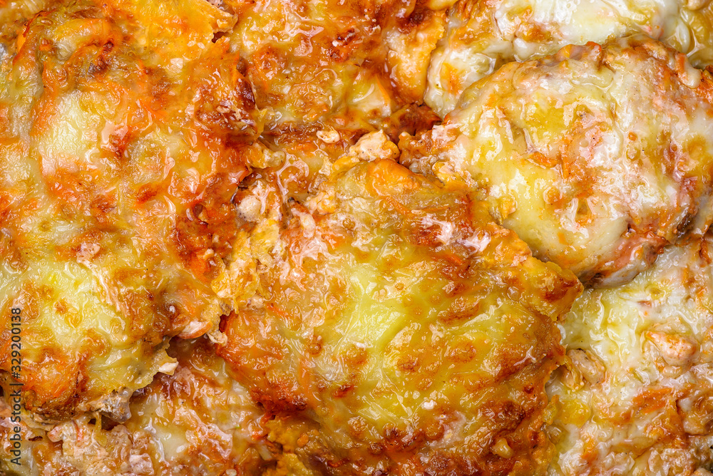 Baked pork steaks with vegetables and cheese. Texture Baked pork steaks with vegetables and cheese. Texture