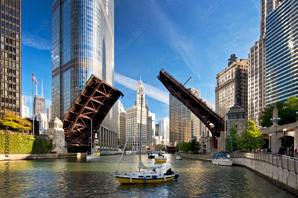 Fototapeta premium The raising of the bridges on the Chicago River signals the end of another sailing season as sailboats move from their harbor on Lake Michigan to their winter dry dock location.