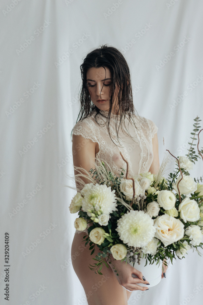 Girl with white roses and amaryllis on a white background