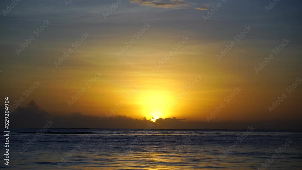 Beautiful sunrise over the Indian Ocean on the island of Zanzibar, Tanzania, east Africa. Travel and nature concept. Sun, blue sky and sea water Beautiful sunrise over the Indian Ocean on the island of Zanzibar, Tanzania, east Africa. Travel and nature concept. Sun, blue sky and sea water