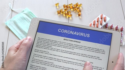 Woman hands reading COVID-19 disease advices on tablet, people informing itself Sars-CoV-2 spread, adult finding out Coronavirus 2019-nCoV epidemic on pad about symptoms and protective measures