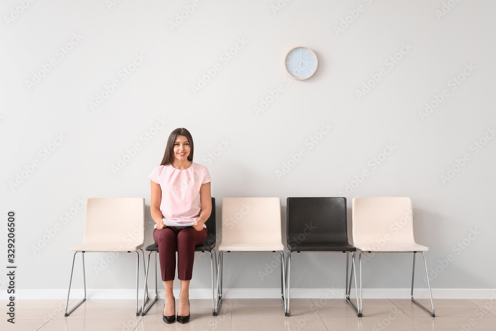 Fototapeta premium Young woman waiting for job interview indoors