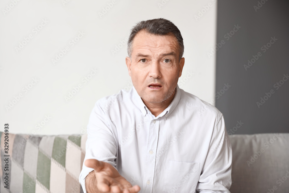 Mature man using video chat at home Mature man using video chat at home