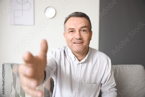 Mature man using video chat...