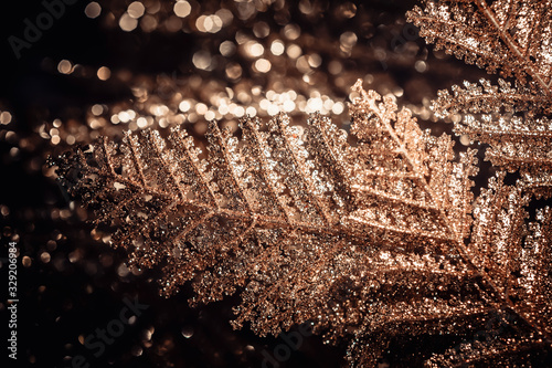 A close-up shot showing the surface of a golden glittering leaf. Use for back...