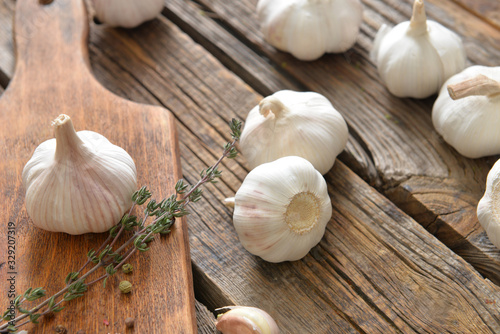 Fresh garlic with spices on wooden table
