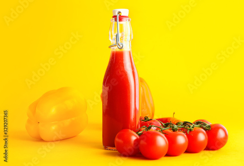 Bottle of fresh vegetable juice on color background